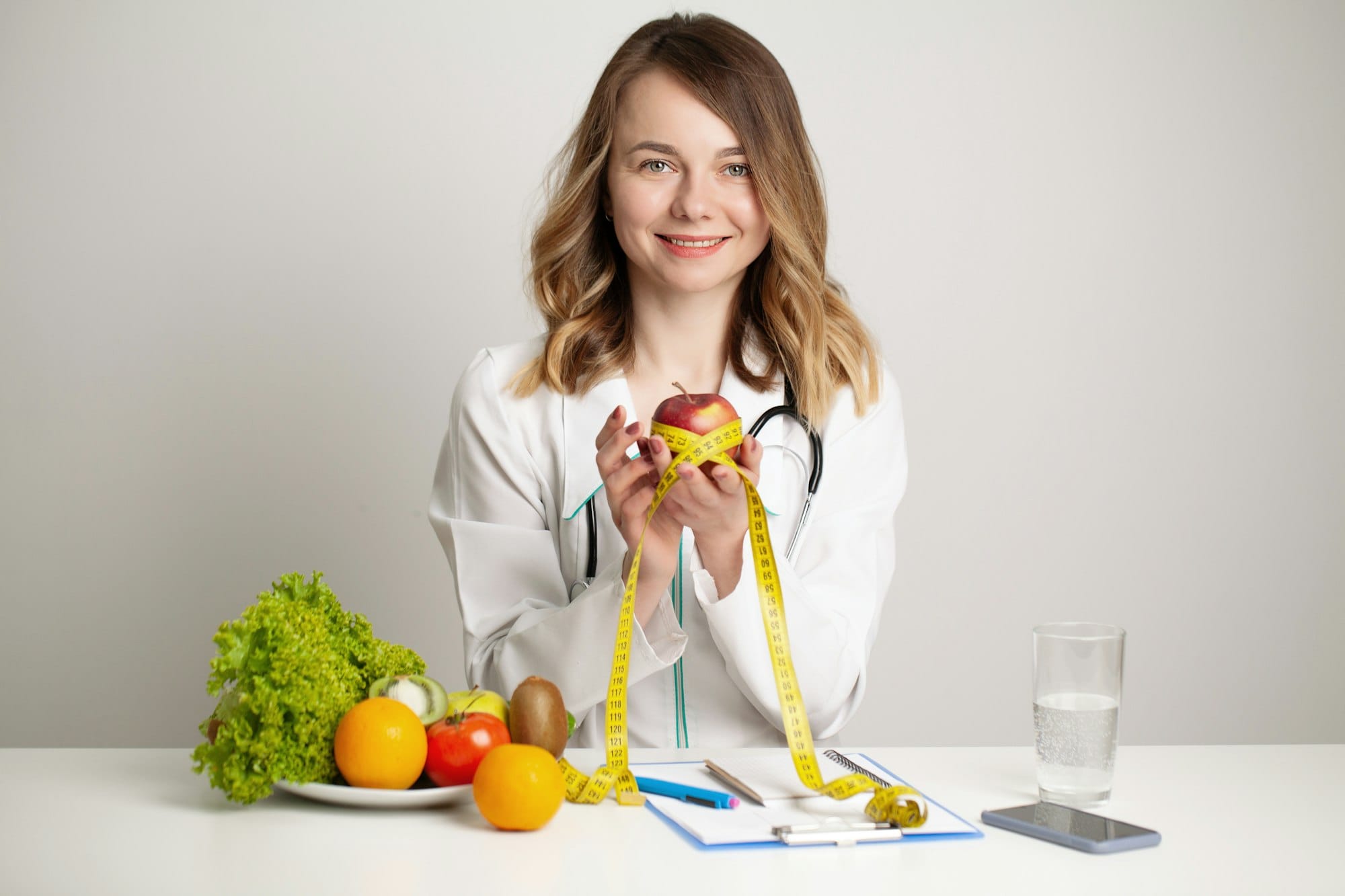 Young nutritionist doctor writing diet plan, healthy eating
